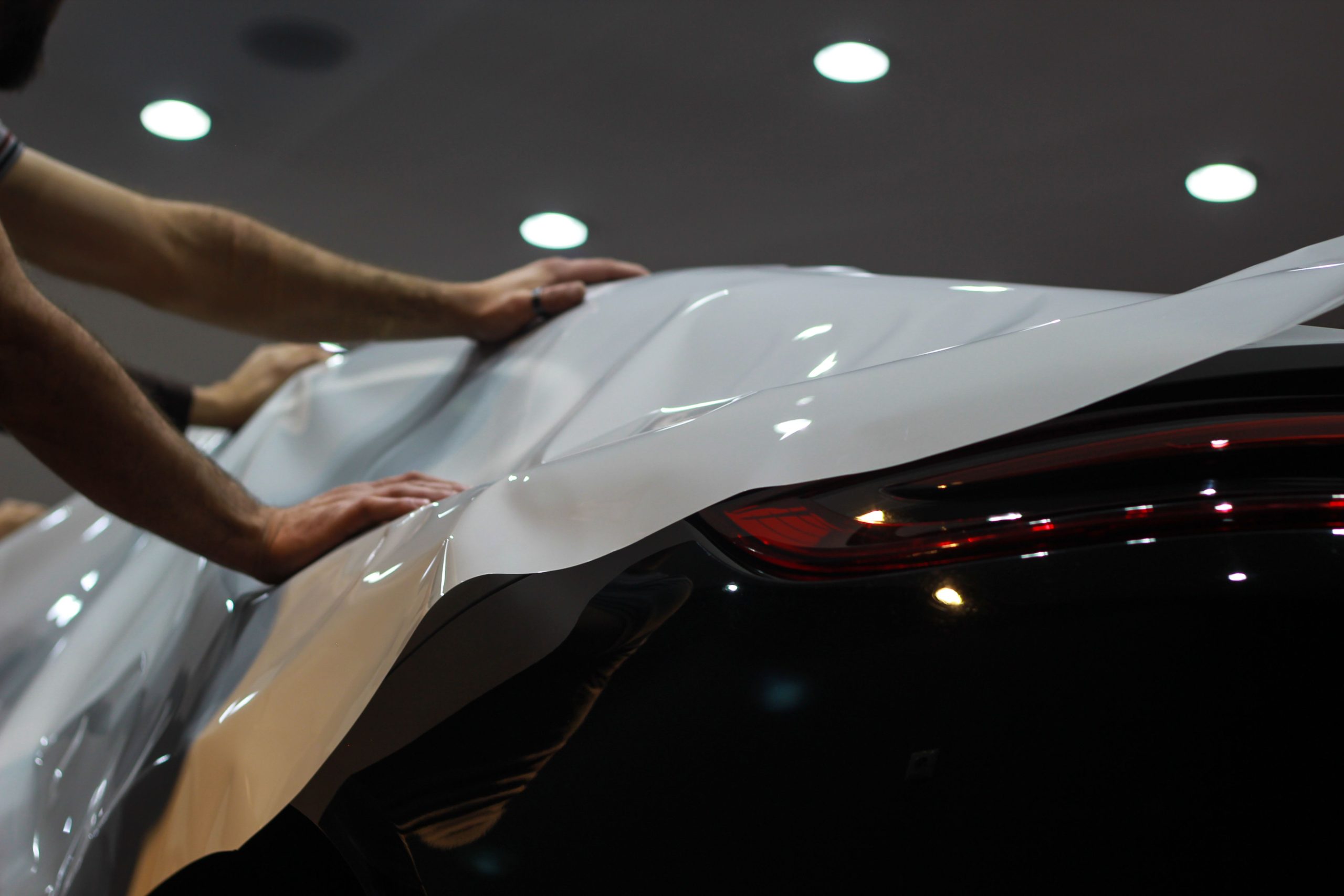 Services Professional car wrapping in progress, showcasing sleek modern vehicle enhancement.